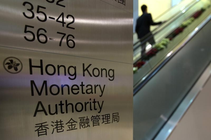 © Reuters. A security guard walks past a directory board of Hong Kong Monetary Authority (HKMA) in Hong Kong