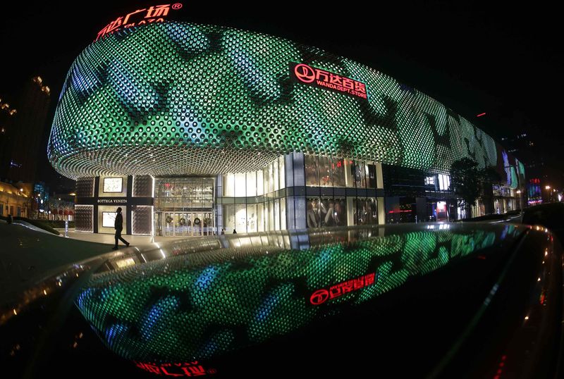 © Reuters. File photo of a man walking in front of an entrance to a Wanda Department Store in Wuhan