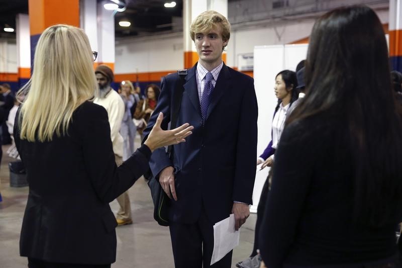 © Reuters. A man speaks to a job recruiter at the Nassau County Mega Job Fair at Nassau Veterans Memorial Coliseum in Uniondale, New York