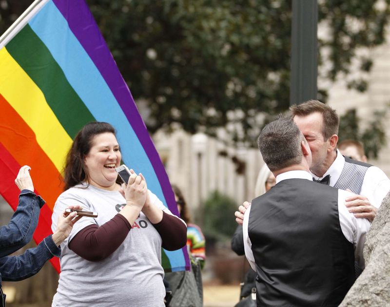 © Reuters. Greg and Roger kiss after getting married in a park outside the Jefferson County Courthouse in Birmingham