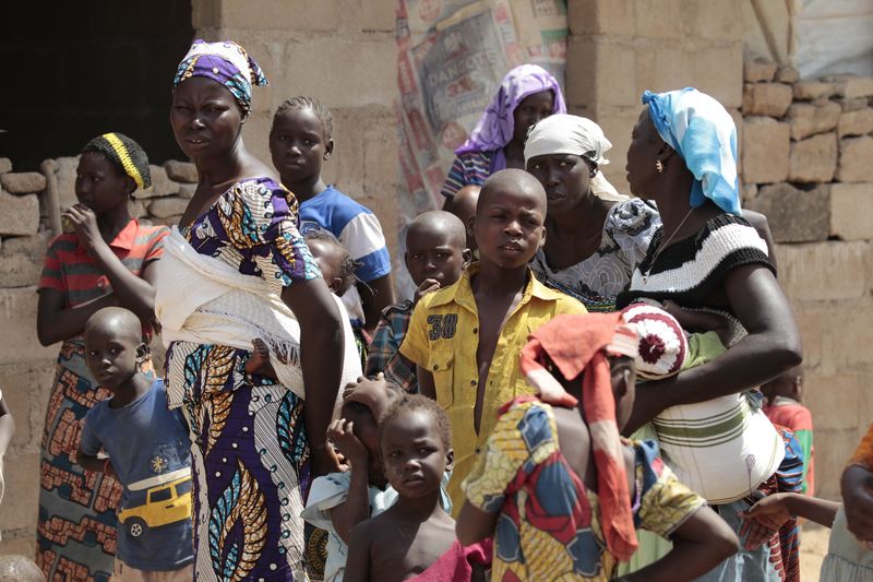 © Reuters. A family, that escaped Boko Haram attacks in both Michika and Cameroon, seek shelter in an uncompleted house in Adamawa