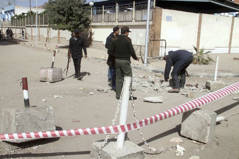 © Reuters. Police investigate the site of a bomb blast in front of Ain Shams police station in Cairo