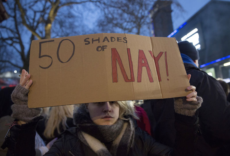 © Reuters. A protester holds a placard to demonstrate against "Fifty Shades of Grey" at the film's UK premiere in London