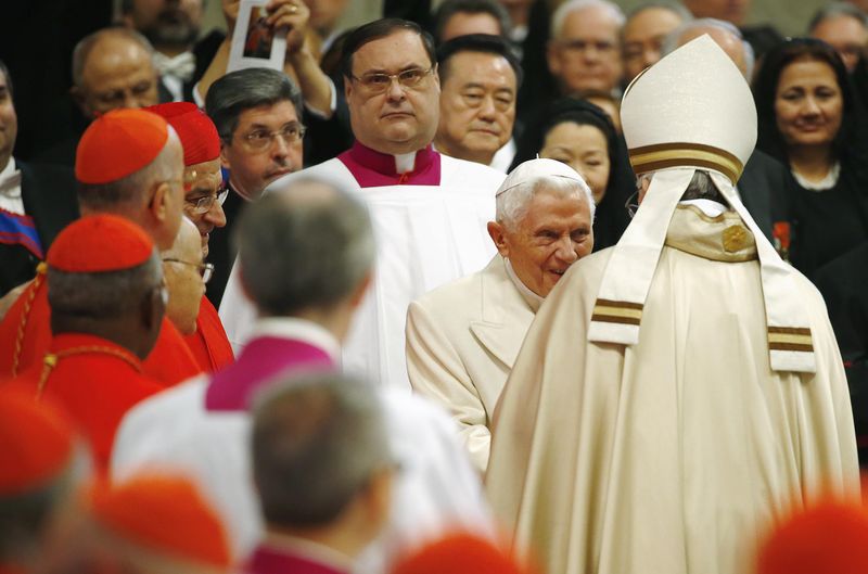 © Reuters. Pope Francis greets Emeritus Pope Benedict XVI before leading a mass to create 20 new cardinals during a ceremony in St. Peter's Basilica at the Vatican
