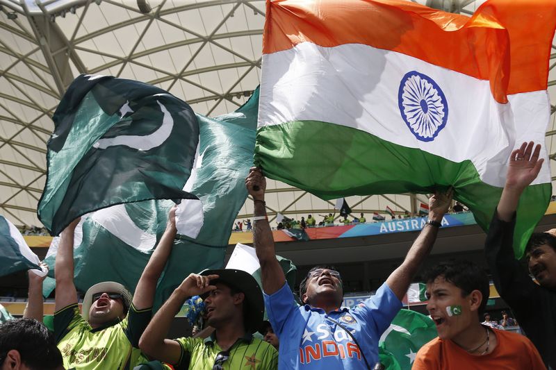 © Reuters. Fans of Pakistan's cricket team and India's cheer in the stands before Pakistan's Cricket World Cup match against India in Adelaide