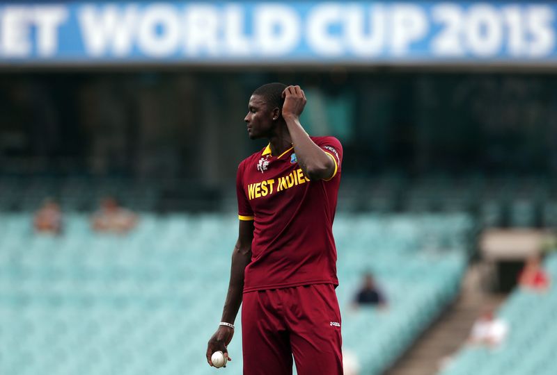 © Reuters. Holder of West Indies reacts after his wicket of England's Ali was declared not out due to Holder's bowling of a no ball during their warm-up match at the Sydney Cricket Ground