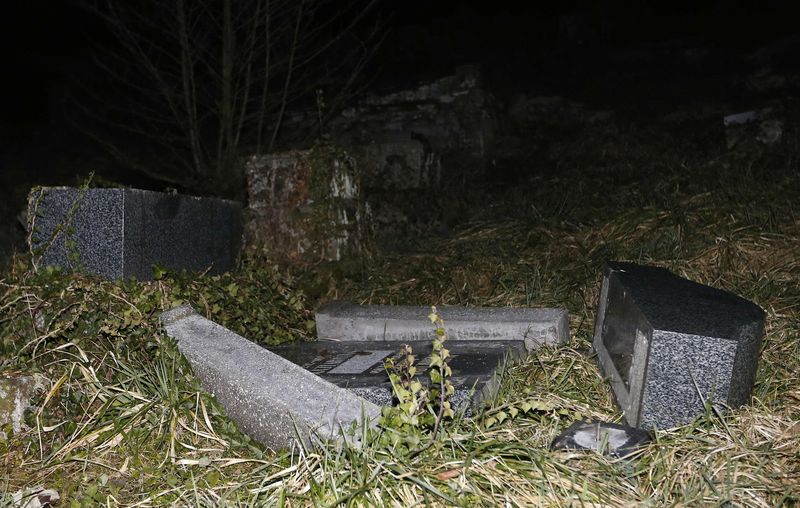 © Reuters. Desecrated tombstones are seen at Sarre-Union Jewish cemetery