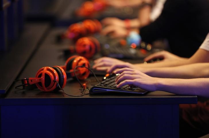 © Reuters. Gamers play "Warlords of Draenor" at the World of Warcraft exhibition stand during the Gamescom 2014 fair in Cologne