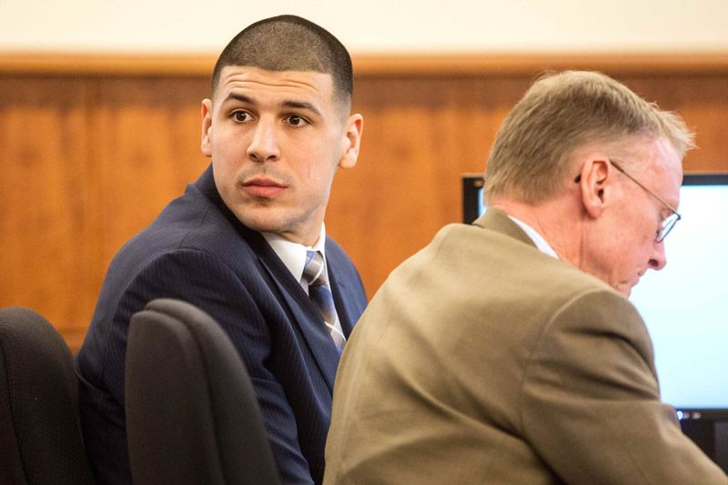 © Reuters. Former New England Patriots football player Aaron Hernandez sits with his attorney Charles Rankin during his murder trial at the Bristol County Superior Court in Fall River