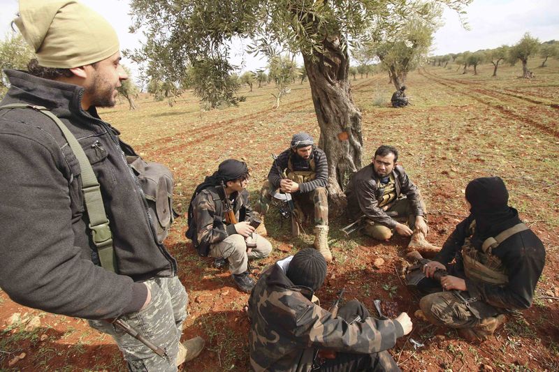 © Reuters. Rebel fighters chat near the front line against forces loyal to Syria's President Bashar al-Assad in Ratian village, north of Aleppo