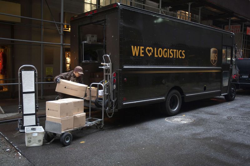 © Reuters. A United Parcel Service delivery person prepares to deliver packages in New York