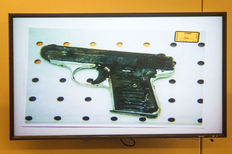 © Reuters. A photo of a small handgun found in a wooded area near the crime scene was displayed during the murder trial of the former New England Patriots player Aaron Hernandez in Fall River