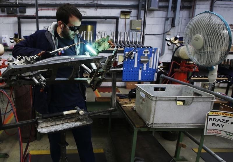 © Reuters. Musa Aumeed  brazes a bike frame at the Brompton Bicycle factory in west London