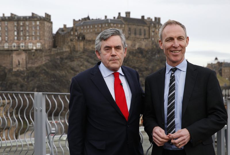 © Reuters. Former British Prime Minister Gordon Brown poses with Scottish Labour Party leader Jim Murphy before delivering his speech on powers for the Scottish Parliament, in Edinburgh