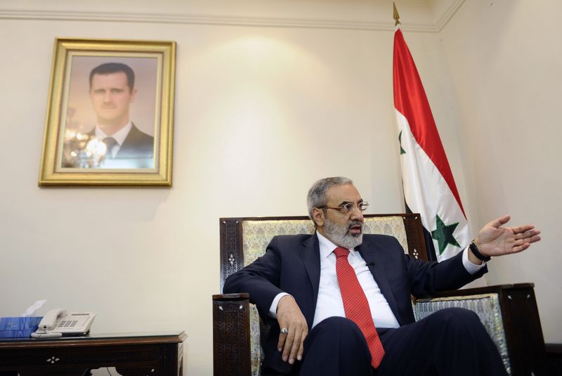 © Reuters. Syria's Information Minister Omran al-Zoabi speaks during an interview with Reuters in Damascus