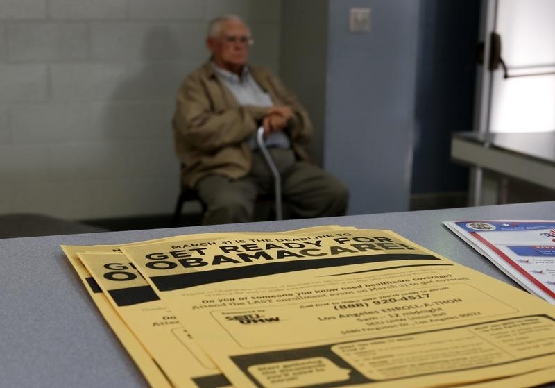 © Reuters. A man sits at a health insurance enrollment event in Cudahy, California