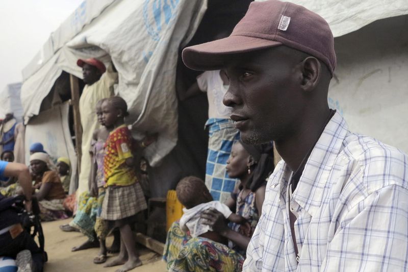 © Reuters. Emmanuel Ali Talka sits in front of his tent with his family of six at the Minawao refugee camp