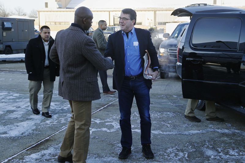 © Reuters. U.S. Defense Secretary Carter is greeted by Senior Military Assistant Lewis as they arrive to travel to Afghanistan from Joint Base Andrews