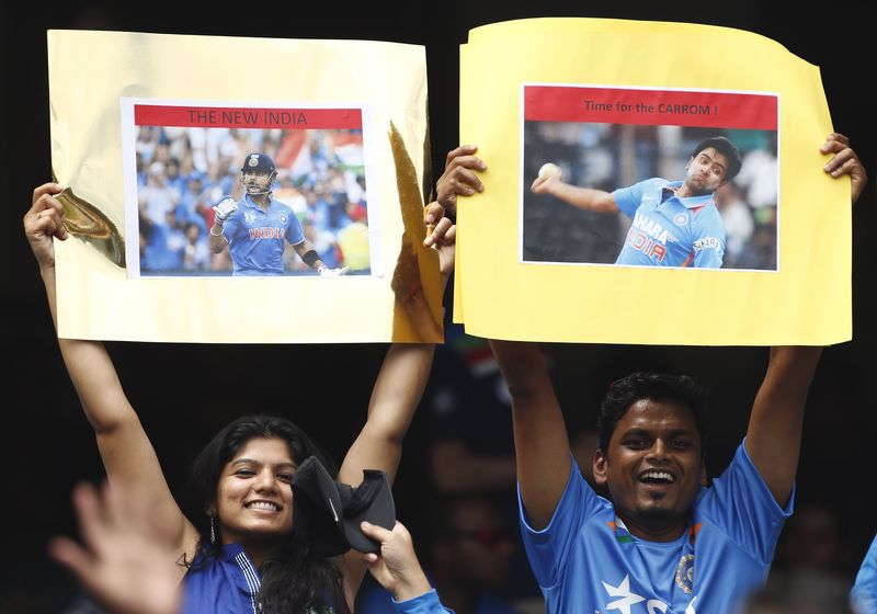 © Reuters. Indian supporters hold up signs before the start of the Cricket World Cup against South Africa at the MCG