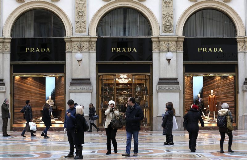 © Reuters. People stroll past Prada's fashion store in downtown Milan