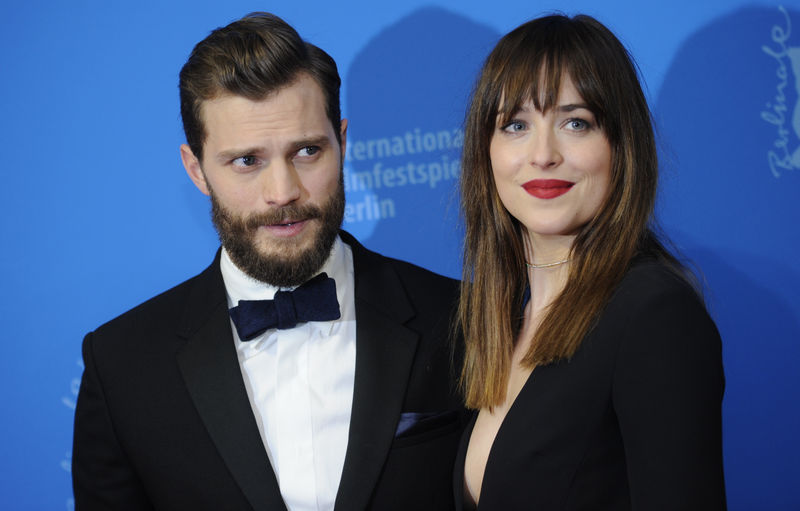 © Reuters. Actors Johnson and Dornan arrive for screening at 65th Berlinale International Film Festival in Berlin