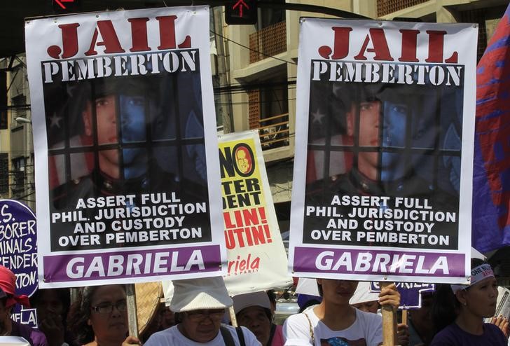 © Reuters. Activists display placards of U.S. Marine Private First Class Joseph Scott Pemberton during a protest outside the presidential palace in Manila