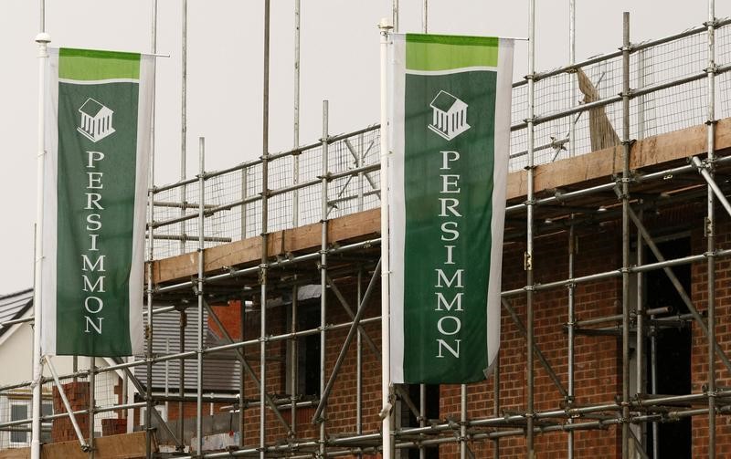 © Reuters. Persimmon banners fly at a housing development near Manchester