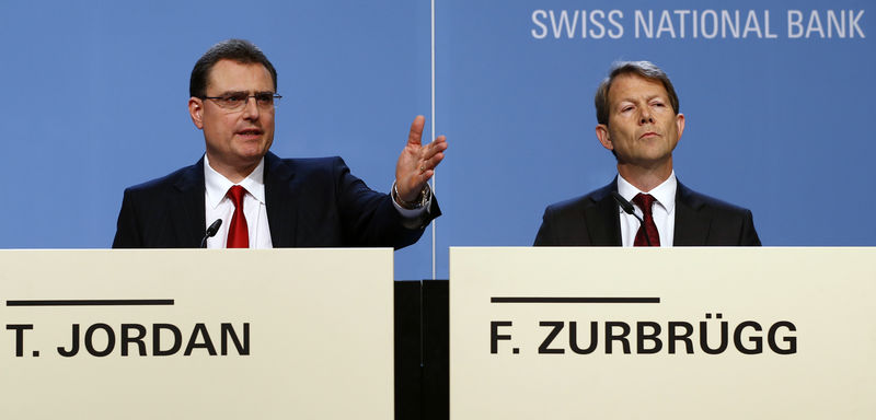 © Reuters. File picture shows Swiss National Bank SNB Chairman Thomas Jordan and board member Fritz Zurbruegg speaking to media during the year end news conference in Bern