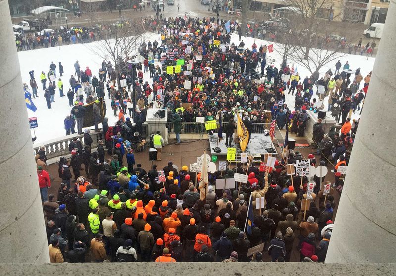 © Reuters. Workers gather outside the State Capitol building in Madison