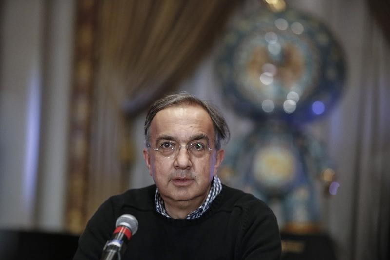 © Reuters. Marchionne, chief executive officer of Fiat Chrysler Automobiles, speaks with the media before ringing the closing bell to celebrate the company's listing at the New York Stock Exchange