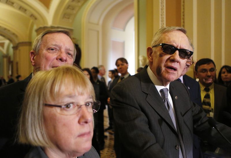 © Reuters. U.S. Senate Minority Leader Harry Reid (D-NV) (R) talks to the media, after a weekly Senate party caucus luncheon on Capitol Hill in Washington