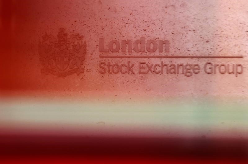 © Reuters. A red London bus passes the Stock Exchange  in London