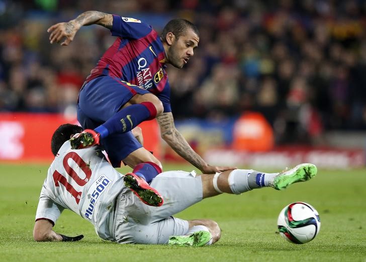 © Reuters. Daniel Alves disputa lance com jogador do Atlético de Madri Arda Turan na Copa do Rei