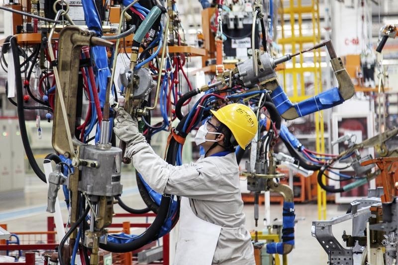 © Reuters. An employee works at the production line of an automobile factory in Dalian