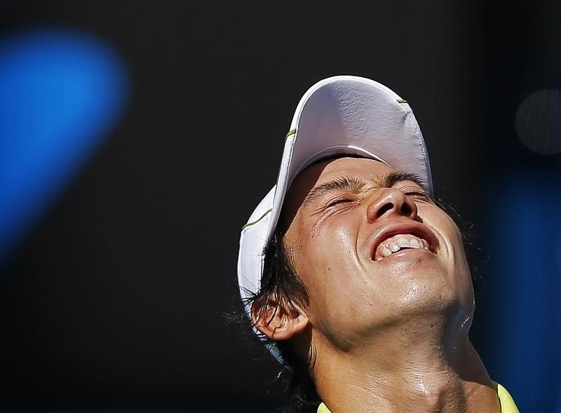 © Reuters. Nishikori of Japan reacts after missing a shot to Wawrinka of Switzerland during their men's singles quarter-final match at the Australian Open 2015 tennis tournament in Melbourne 