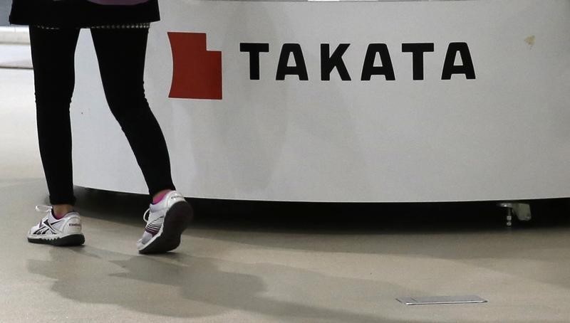 © Reuters. Visitor walks past displays of Takata Corp at a showroom for vehicles in Tokyo
