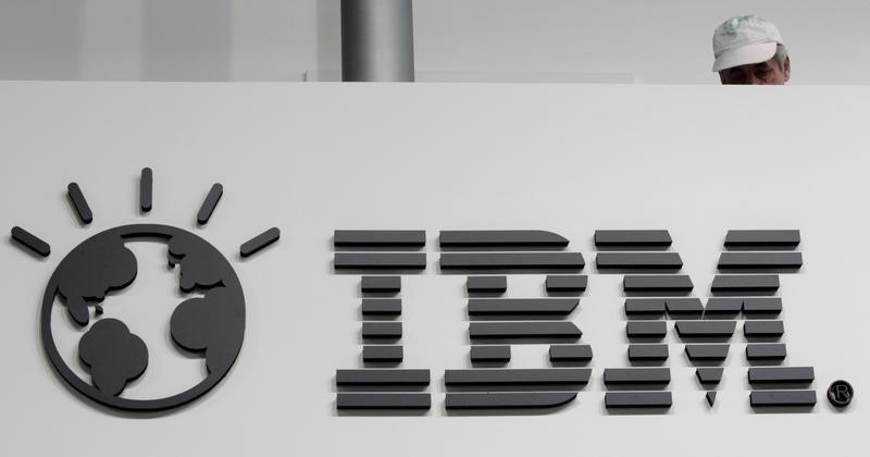 © Reuters. A worker is pictured behind a logo at the IBM stand on the CeBIT computer fair in Hanover