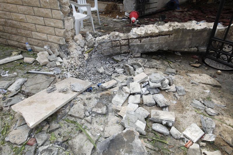 © Reuters. A general view of the damage caused by a bomb blast is seen at the gate of the Iranian ambassador's residence in Tripoli