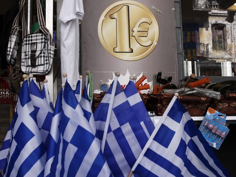 © Reuters. Greek national flags are displayed for sale at the entrance of a one Euro shop in Athens