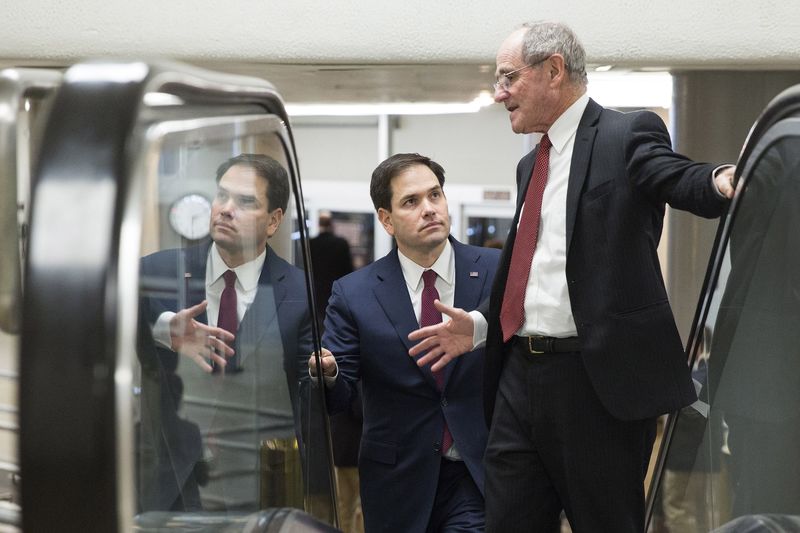 © Reuters. Senators Marco Rubio (R-FL) and Pat Toomey (R-PA) speak as they walk to the Senate Chamber to vote on legislation for funding the Department of Homeland Security