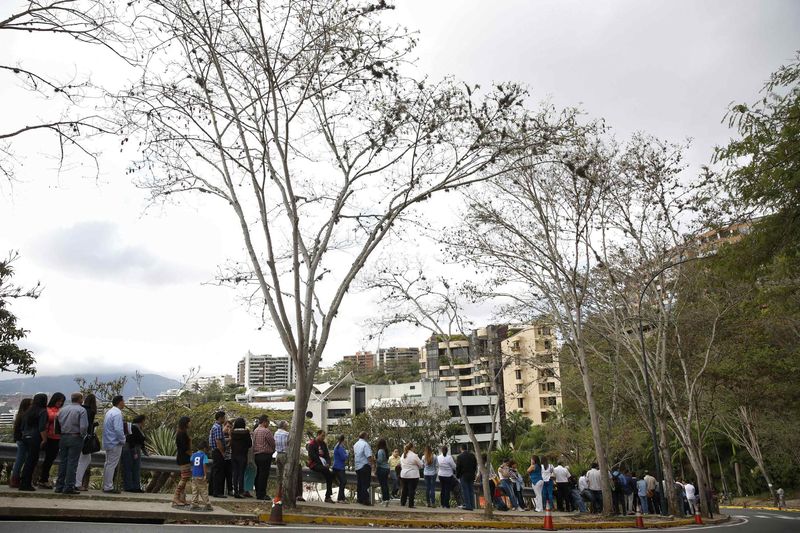 © Reuters. People form a line outside the U.S. embassy in Caracas