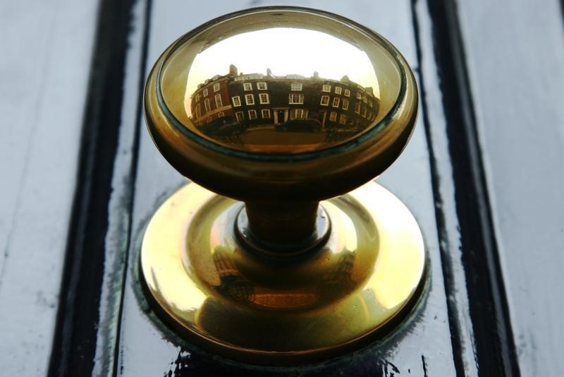 © Reuters. Houses are reflected in the door handle of a property in central London