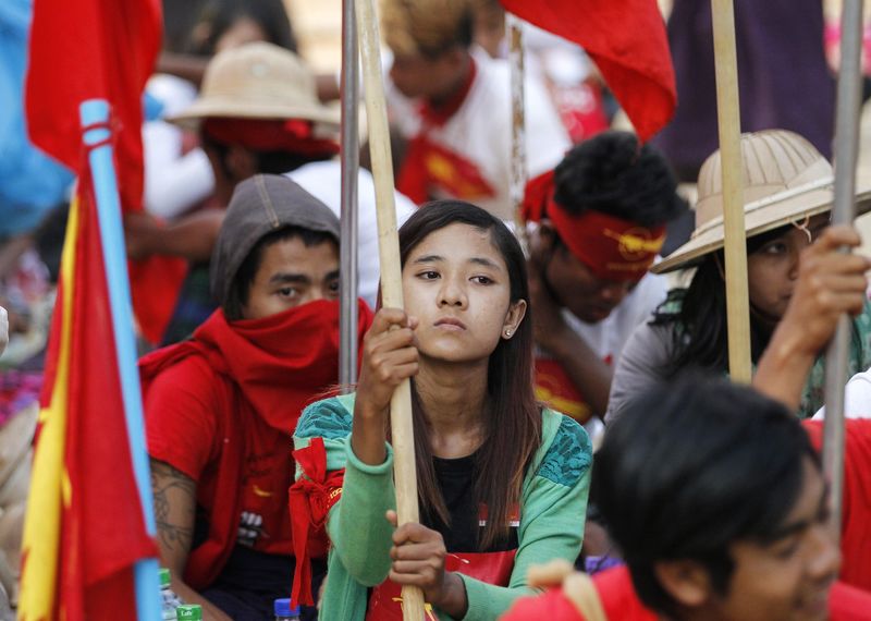 © Reuters. Students sit as they take part in a protest against an education bill in Letpadan