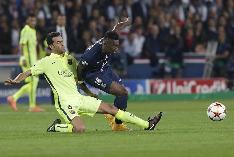 © Reuters. Paris St Germain's Bahebeck challenges Barcelona's Busquets during their Champions League Group F soccer match at the Parc des Princes Stadium in Paris