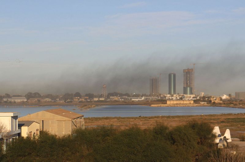 © Reuters. Smoke rises after an airstrike hit Maitiga airport early Thursday morning, in Tripoli