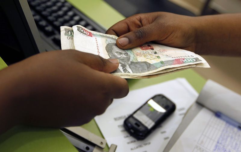 © Reuters. File photo of a customer conducting a mobile money transfer inside the Safaricom mobile phone care centre in Nairobi