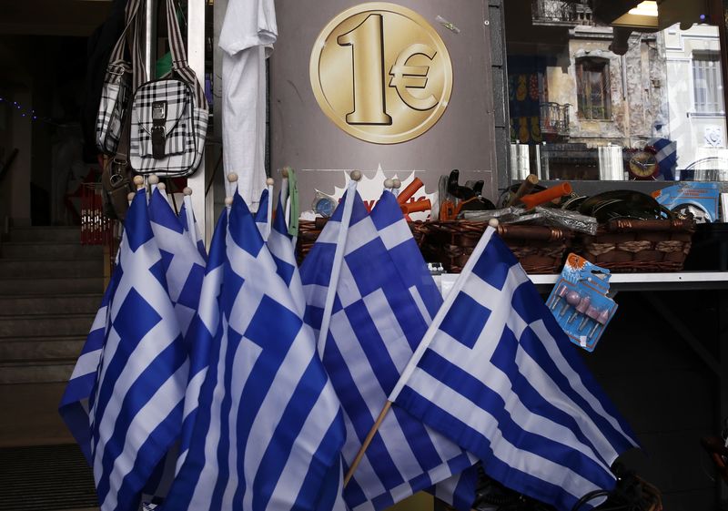 © Reuters. Greek national flags are displayed for sale at the entrance of a one Euro shop in Athens