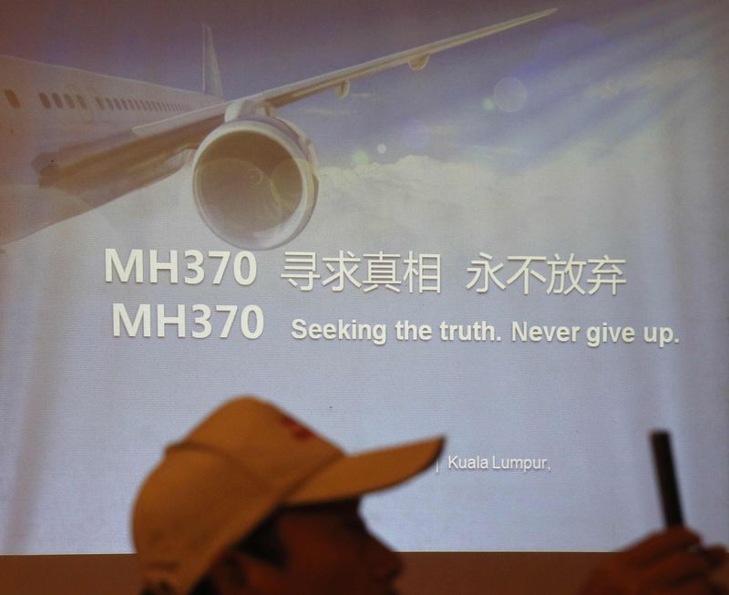 © Reuters. Relatives of some of the Chinese passengers who were on board MH370 outline their demands to the airline in Kuala Lumpur