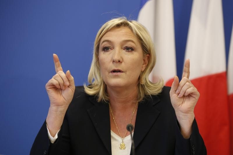 © Reuters. France's National Front political party head Marine Le Pen gestures as she speaks during a news conference at the party headquarters in Nanterre near Paris