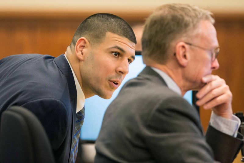 © Reuters. Former New England Patriots player Aaron Hernandez speaks with his attorney Charles Rankin during his murder trial at the Bristol County Superior Court in Fall River